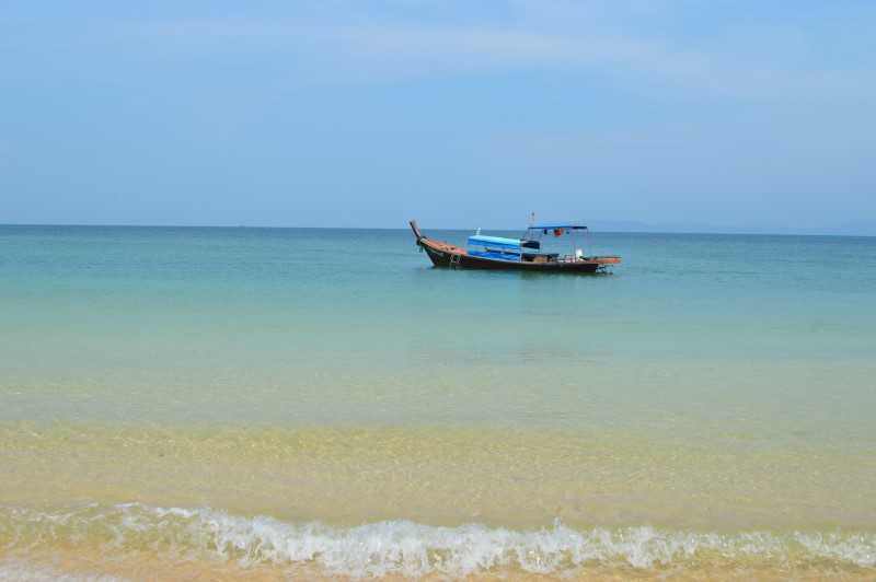 Longboat at anchor near beach, Thailand's secret Islands