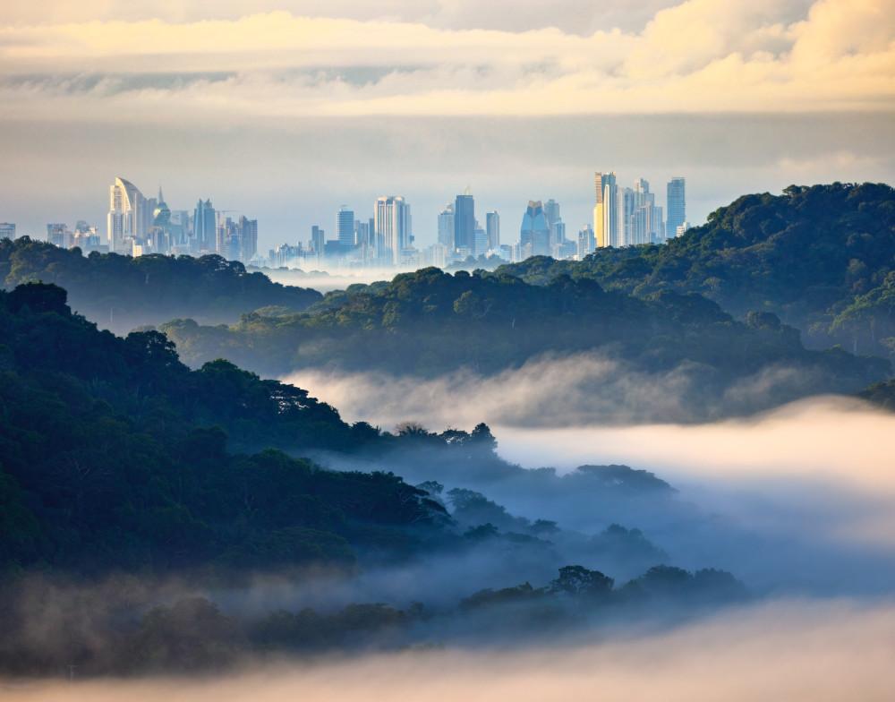 Rain forest mist surrounds the Panama Canal as Panama City lies in background. (Panama Tax Haven)
